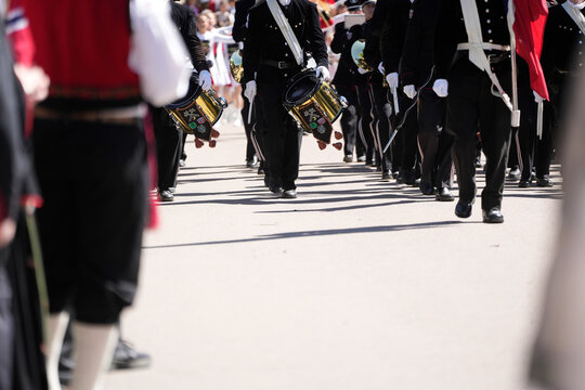 Golden Snare Drums and Black Uniforms &ndash; Marching Band in Formation on Sunlit Parade Street During Norwegian National Day