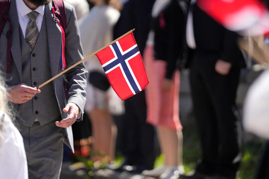 Hand Holding Small Norwegian Flag &ndash; Close-Up at Outdoor Syttende Mai National Day Celebration
