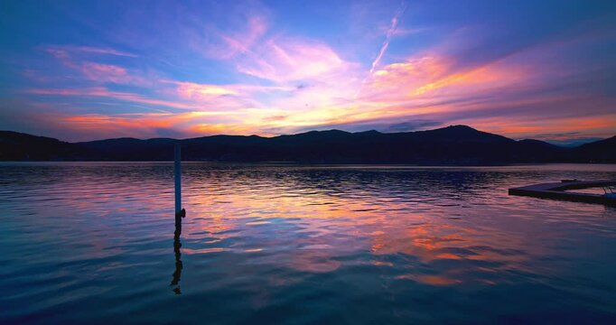 Pink sunset over the port of Ranco on lake Maggiore in Italy