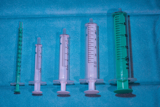 Set of Different Sized Empty Medical Syringes (1ml to 20ml) on Blue Sterile Drape - Healthcare and Nursing Equipment
