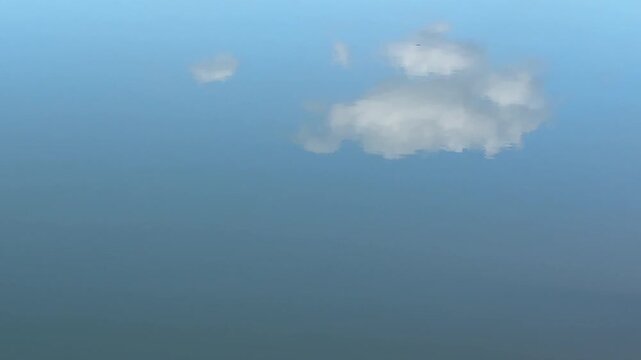 Minimal Blue Water Surface with Soft Cloud Reflection and Wide Copy Space
