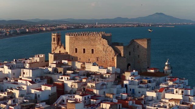 drone close up view of Peniscola castle in Italy, Provence of Valencia, holiday in Spain, Spanish medieval town of Peniscola on the Mediterranean coast, aerial sunset view