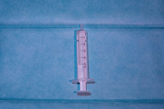 Single Empty 5ml Medical Syringe on Blue Sterile Drape - Standard Clinical Healthcare Supply