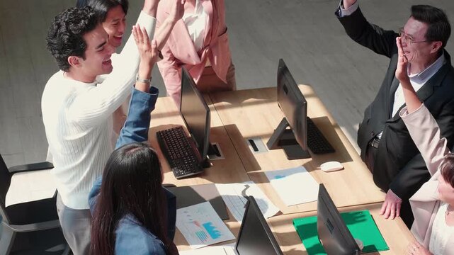 Diverse business team stacking hands with success together, joyful celebration of corporate achievement and career success, management team building unity for company goal in modern office.