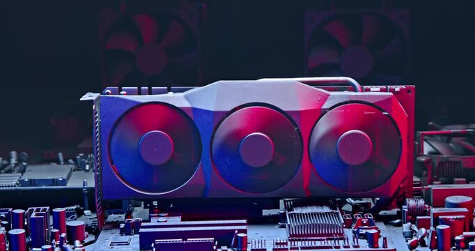 Spinning fans on graphics card on motherboard among computer parts.