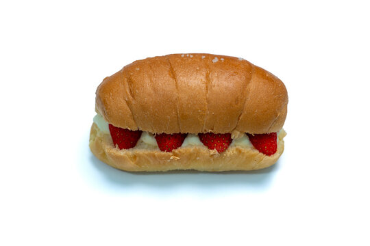 Shio Pan, Salted baked bread with soft cream and strawberry on isolated white background. Top view.
