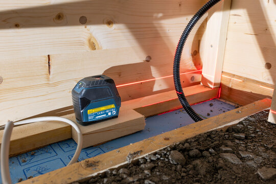DRESDEN, GERMANY - 17. February 2026: Bosch GCL 2‑15 Professional tool at a construction site. Using the laser lines to drill holes into the wall and mount things. Equipment for house building.