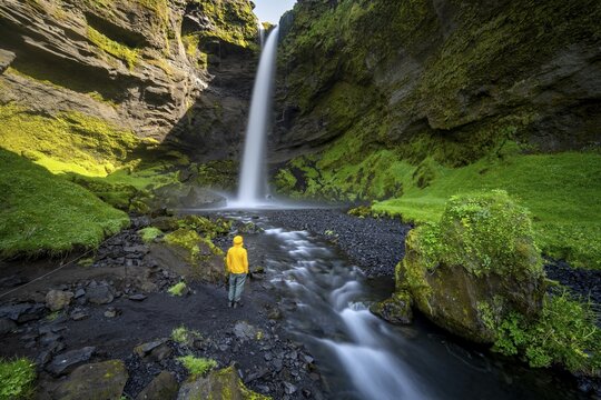 Tourist at Kvernufoss waterfall, in summer when the weather is nice, gorge and river, long exposure, Skogar, Sudurland, South Iceland, Iceland