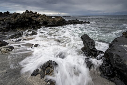 Waves blaze on the beach, rocky coast with volcanic stones, long exposure, Playa de la Peque&ntilde;a, Punta Usaje, Lanzarote, Canary Islands, Spain