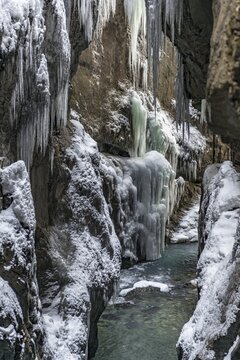 Wild river Partnach in the Partnachklamm with long icicles and snow in winter, near Garmisch-Partenkirchen, Upper Bavaria, Bavaria, Germany