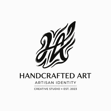 A black and white logo for 'Handcrafted Art' featuring a stylized brushstroke monogram and text 'Artisan Identity Creative Studio Est. 2023'.