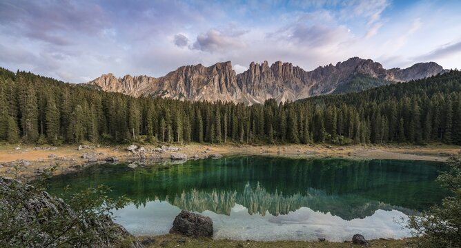 Sunset, dramatic clouds, Latemar group reflected in the Karersee, Diamantidturm, mountain peaks, Eastern Latemarspitze, Col Coron, Lago di Carezza, Welschnofen, Bolzano, South Tyrol, Italy