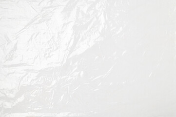 Obraz premium Close-up of cling film texture on gray background. Transparent plastic food wrap, abstract background with space for text
