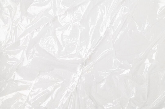 Close-up of cling film texture on gray background. Transparent plastic food wrap, abstract background with space for text
