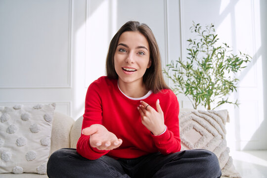 Young woman talking and gesturing during a video call, webcam view