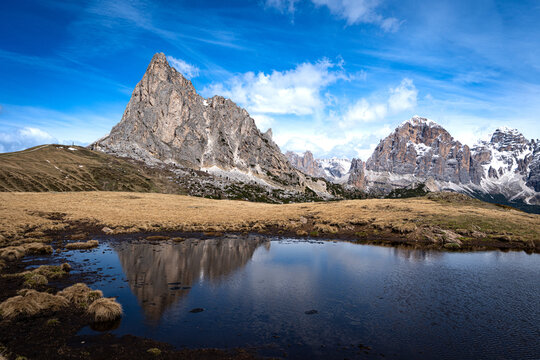Ra Gusela and Snow-Capped Dolomite Peaks Reflected in Alpine Pond at Passo Giau, Italy