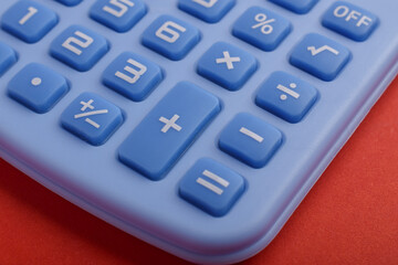Fototapeta premium Closeup of calculator buttons on red background representing accounting, mathematics, budgeting, financial calculation, statistics, business analysis, and office finance concept.