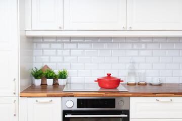 Minimalist scandinavian kitchen design. Red saucepan. White colors, clean, bright style © olgakudryashova