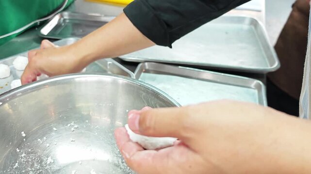 Close-up of hand making traditional Thai tapioca pearls dumplings.