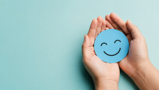 Hands Holding Happy Face Mental Wellbeing Concept