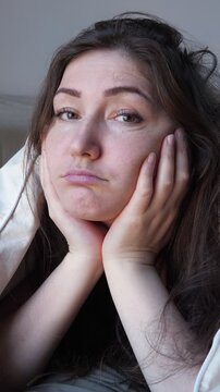 Woman Observes Patiently. Woman Patiently Waits As Moments Drift Slowly. Bored Woman Sits And Observes Slow Passage Of Time. Woman Quietly Endures As She Watches Time Move At Sluggish Pace