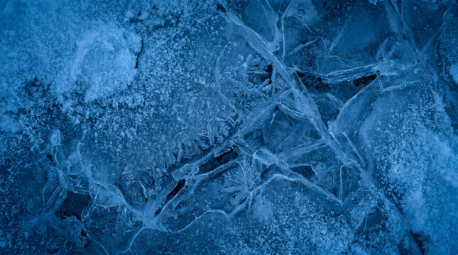 A frozen blue ice surface with cracks.