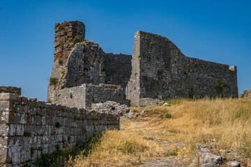 The weathered interior walls and remnants of structures within the ancient Rozafa Castle illustrate its rich history and enduring legacy in Shkoder, Albania. © Danica Chang