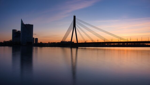 Vansu Bridge Silhouette and Modern Skyline at Sunset in Riga Latvia