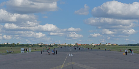  People walking, biking and skating on the tarmac of Tempelhof, old airport that serves now as city park in Berlin, Germany  © Kristof Lauwers
