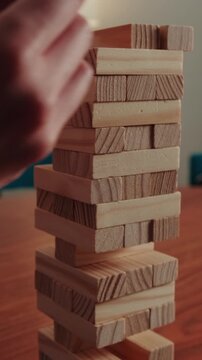Focused Hands Playing Stacking Blocks Jenga Game