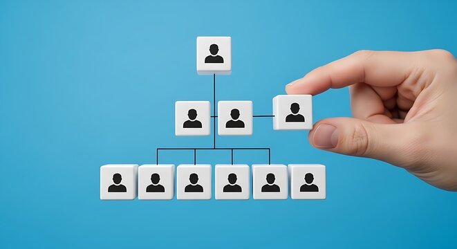 A hand placing a block with a person icon into a hierarchical organizational chart structure on a blue background