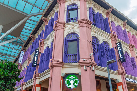 Singapore - 26 December, 2025: Shophouse of a colorful colonial-style pink and white  building with violet shutters and Starbucks logo on facade on Smith street in Chinatown, Singapore.