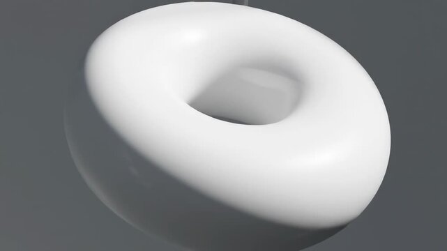 A white glossy torus shape against a gray gradient background, rendered