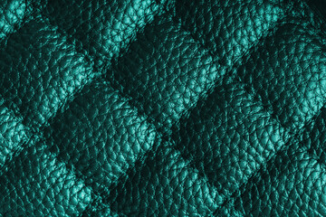 Fototapeta premium Close up, macro of turquoise quilted leather texture with stitched diamond pattern, luxury material surface shining metal effect for fashion, upholstery or design wallpaper, rough, relief background