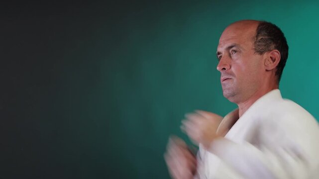 A young athlete practices punching against a multi-colored background with flashing red and green lights