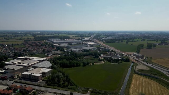 Aerial Cityscape: An expansive aerial view showcases a vibrant cityscape with a blend of industrial and residential areas, interwoven by roads and enveloped in a clear, bright atmosphere.