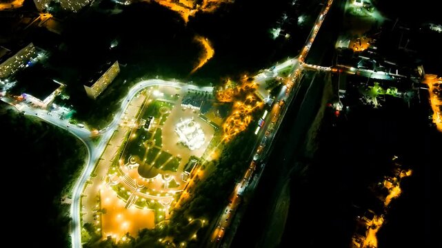 Gelendzhik, Russia. Cathedral of St. Andrew the First-Called, snow-white walls and golden domes illuminated against the night, Drone footage over Andreevsky park and the Black Sea coast. Drone footag