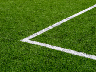 Fototapeta premium Corner marking on green football field grass with white painted lines