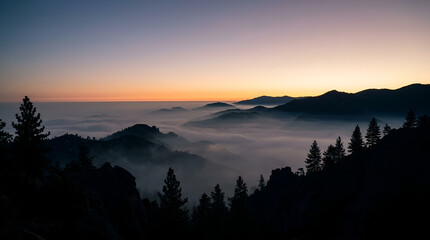 Obraz premium Stunning sunset view over mountain ranges covered by sea of clouds.