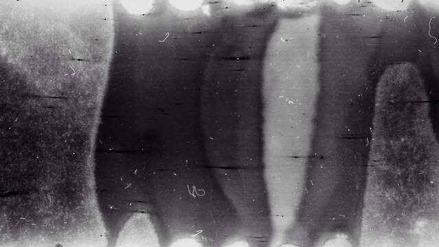 Blank grained film strip texture background with heavy grain, dust and light leak. Old expired soviet moldy photographic film scan. Black and white.