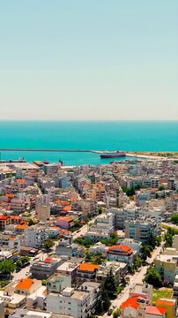 Vertical video. Alexandroupolis, Greece. Panorama of the central part of the city in summer. Coast of the Thracian Sea. Drone footage. Rich colors