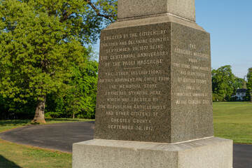 Fototapeta premium Malvern, Pennsylvania, USA – May 8th 2026 - 1877 granite monument honoring those involved in the Paoli Massacre, located at Paoli Battlefield Historical Park.