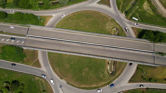 Road Roundabout Aerial: An aerial perspective of a road roundabout, showcasing the organized flow of traffic, the green of the landscape, and the engineering of transport routes. 
