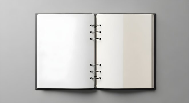 Open ring binder planner with blank pages on a grey background