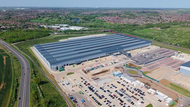 Drone shot flying over a modern distribution center and HGV loading bays in Kettering UK