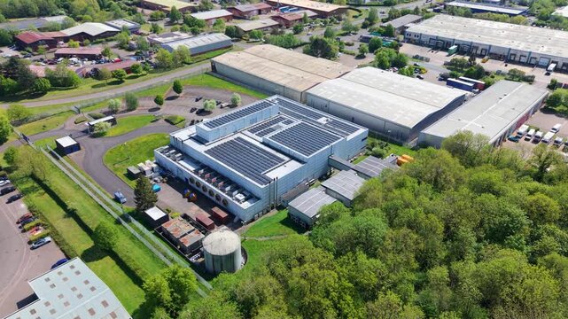 Close up aerial drone view of a large modern data center building with ventilation cooling systems on an industrial estate UK