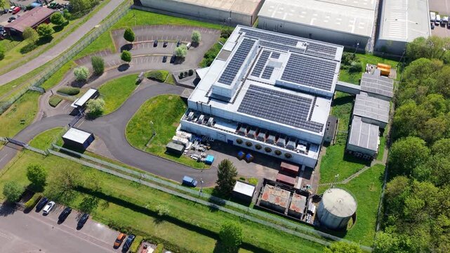 Close up aerial drone view of a large modern data center building with ventilation cooling systems on an industrial estate UK