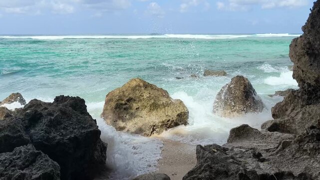 Ocean Waves Crashing Against Rocks at Gunung Payung Beach Bali