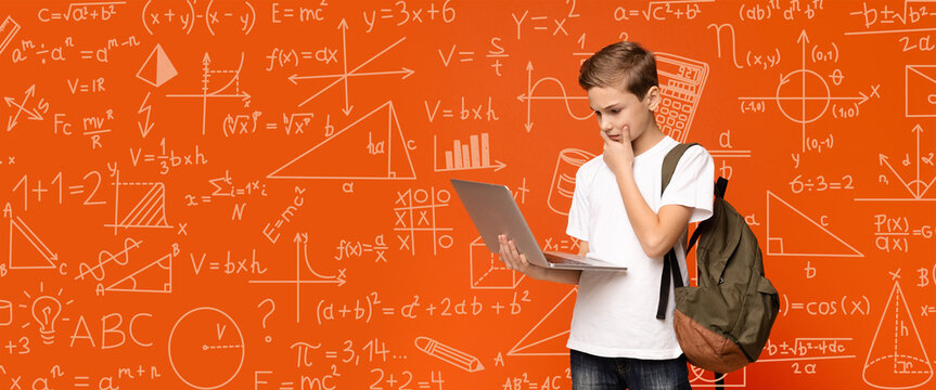 A student stands with a laptop in a room filled with math and science equations on the wall. He appears focused and engaged, thinking about his studies.