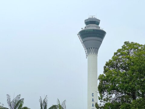 Modern air traffic control tower rising above the tarmac at Kuala Lumpur International Airport, Malaysia, May 2025